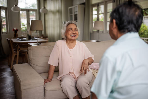 istock Elderly Thai Couple Talking in Living Room 2199183260
