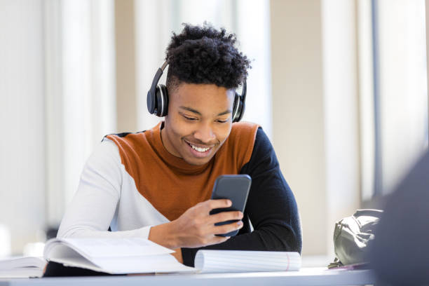 istock Young African American Male Student Using Smart Phone 2199184286