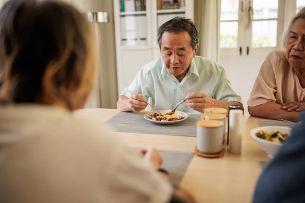 istock Two Senior Thai Couples Enjoying a Meal Together 2199184982