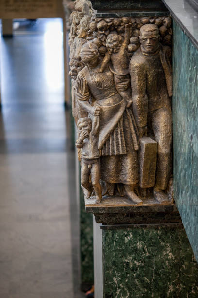 This editorial photograph features the stunning interior of the Palace of Justice in Sofia, Bulgaria, showcasing a collection of elegant statues. These meticulously crafted figures, positioned within the grand hall, embody the rich history and cultural heritage of the Bulgarian judicial system. The interplay of light and shadow enhances the intricate details of the sculptures, while the surrounding architectural elements contribute to the overall grandeur of this iconic building. This image serves as a testament to the artistic and historical significance of the Palace of Justice.