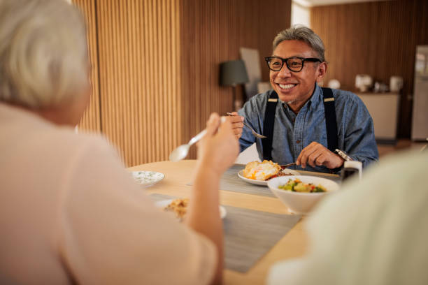 istock Senior Thai Friends Enjoying a Meal at Home 2199185151
