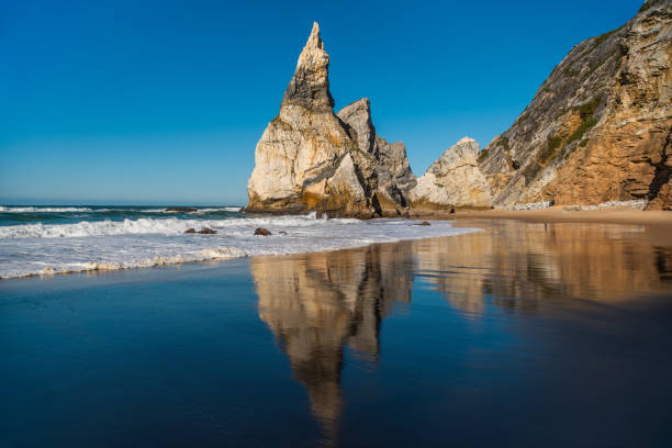 istock Sunny Day at Ursa Beach: Reflection of Rocha da Ursa and Dramatic Sea Stack Rock Formations, Portugal 2199185714