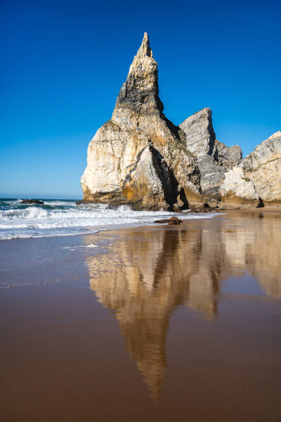 istock Sunny Day at Ursa Beach: Reflection of Rocha da Ursa and Dramatic Sea Stack Rock Formations, Portugal 2199185715