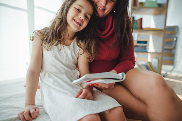 mom reading a novel to the daughter