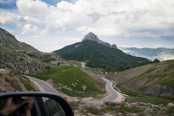 Tourist taking a road trip, driving to the mountain. Summer vacation travelers seek Bosnian  scenic natural destinations to experience mountain range landscape views, majestic, tranquil wilderness areas, and beauty in nature. Sunny day and blue sky