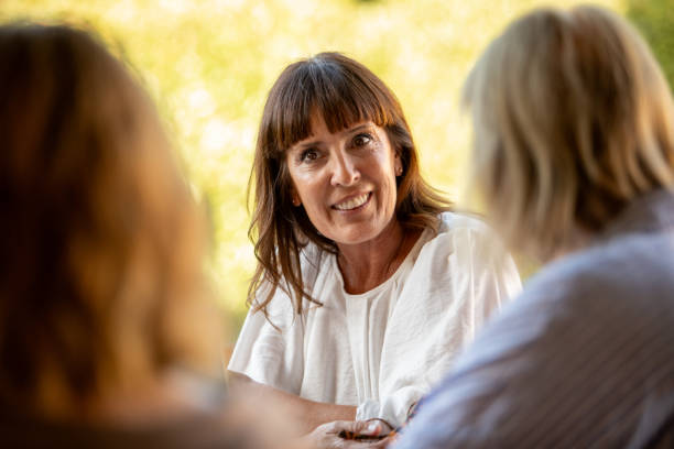 istock Female coordinator leading group therapy for older women 2199206082