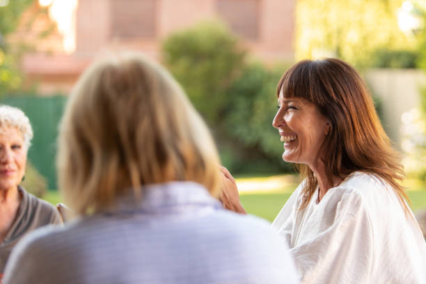 istock Female coordinator leading group therapy for older women 2199206997