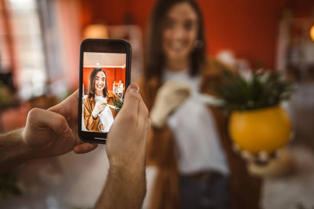 istock woman gardner give an interview for a video blogger while man filming 2199210831