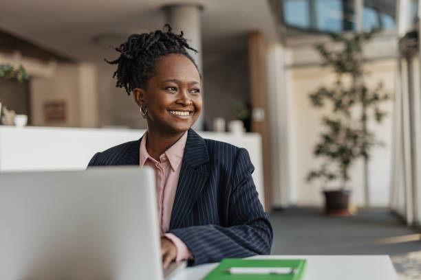 istock Happy Professional Woman Smiling with Laptop 2199211527