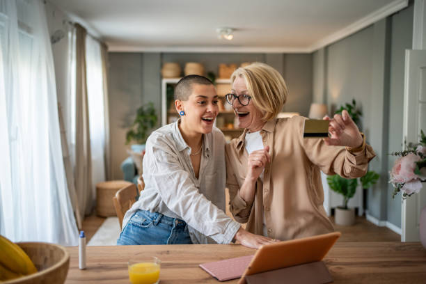 istock Two mixed-age women browsing an online store with a tablet and credit card 2199237831