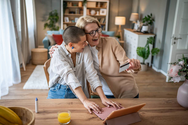 istock Women shopping online using digital tablet and credit card at home 2199238024