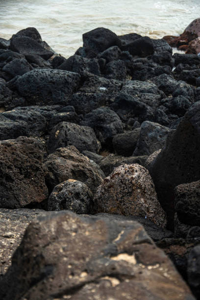 istock a rocky shore of poiupu beach 2199242925