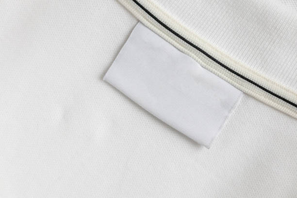 istock Blank white laundry care clothes label on white shirt fabric texture background 2199243852