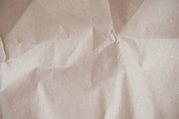 Old paper vintage texture surface for background. Recycle pale brown paper crumpled texture, Cream color recycled kraft paper texture blank with copy space for text.