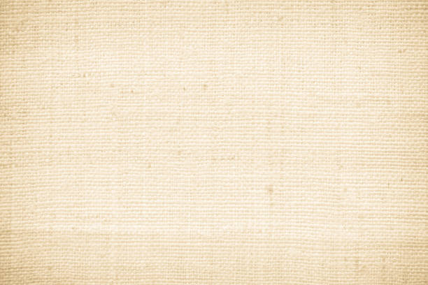 Fabric canvas woven texture background in pattern in light beige cream brown color blank. Natural gauze linen, carpet wool and cotton cloth textile as sack material clean empty for decoration text.