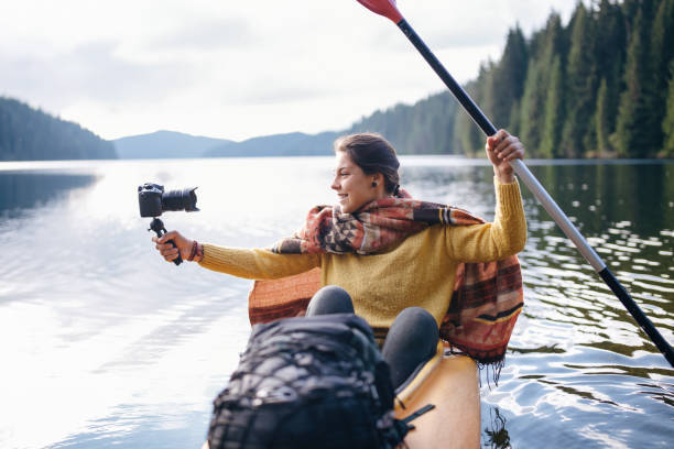 istock Kayaking through breathtaking landscapes while sharing the journey online. 2199247712