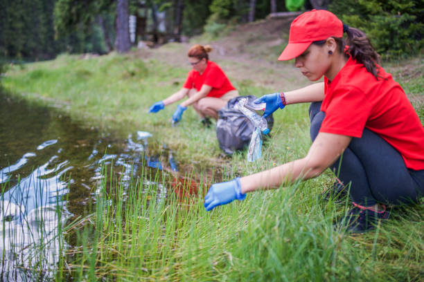 istock Caring for nature: volunteers removing litter from a green space. 2199247723