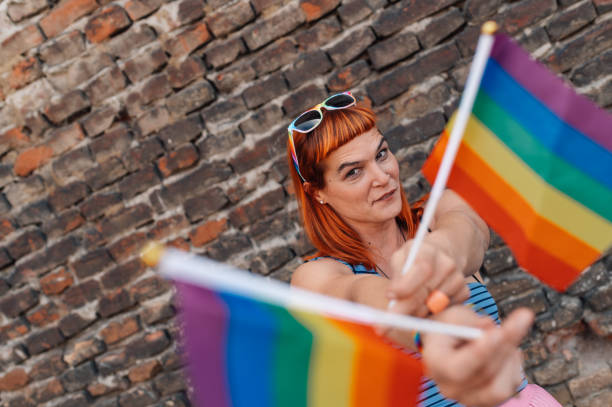 istock Activist showing rainbow flags in front of brick wall 2199248355