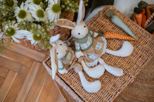 istock Soft fabric bunnies with decorative carrots in a cozy setting 2199249038