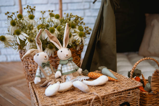 istock Handcrafted bunny dolls and decorative carrots in a cozy indoor setting 2199249046