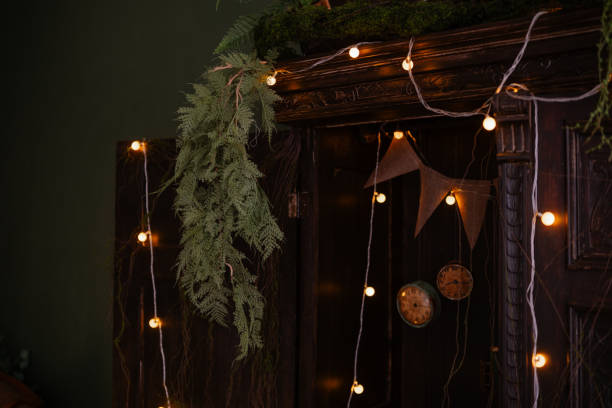istock Decorated shelf with warm string lights and green foliage in cozy setting 2199249249