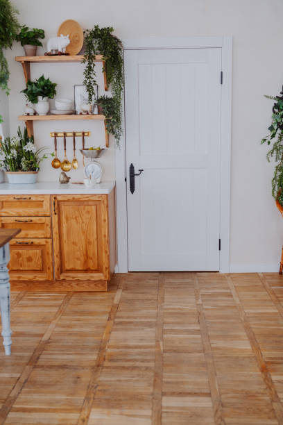 istock Bright and airy kitchen space with wooden shelves and door 2199249472