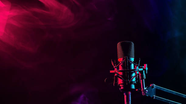 istock Professional microphone in pink smoke on a black background. 2199257178