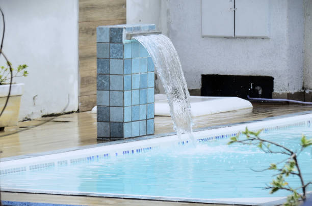 istock In the pool, the water falling from the waterfall 2199261513