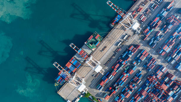 istock Tug boat pulling Cargo container ship go to international yard port. technology freight shipping with smart port. Cargo ship at logistic warehouse. 2199263900