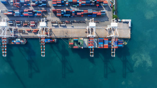 istock Tug boat pulling Cargo container ship go to international yard port. technology freight shipping with smart port. Cargo ship at logistic warehouse. 2199263902