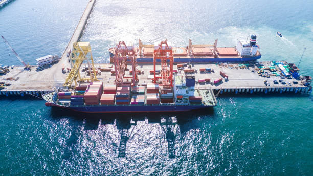 istock Tug boat pulling Cargo container ship go to international yard port. technology freight shipping with smart port. Cargo ship at logistic warehouse. 2199263930