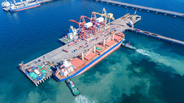 istock Tug boat pulling Cargo container ship go to international yard port. technology freight shipping with smart port. Cargo ship at logistic warehouse. 2199263969