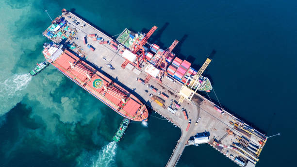 istock Tug boat pulling Cargo container ship go to international yard port. technology freight shipping with smart port. Cargo ship at logistic warehouse. 2199263993