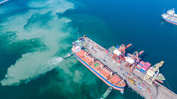 istock Tug boat pulling Cargo container ship go to international yard port. technology freight shipping with smart port. Cargo ship at logistic warehouse. 2199263999