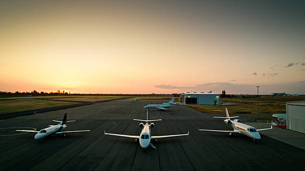 Four private jets on the runway, shot at sunset. This drone shot was taken with full permission and co-operation of the airport staff and the pilots of the aircraft.