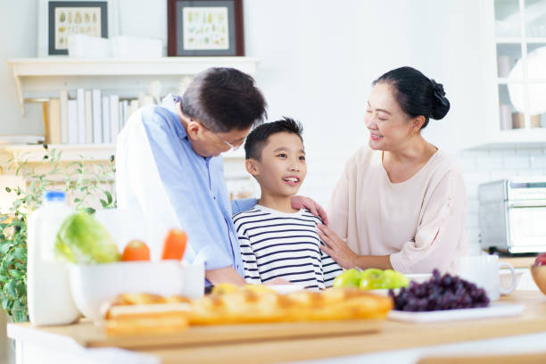 istock Happy Asian family have a breakfast together in kitchen. 2199268692