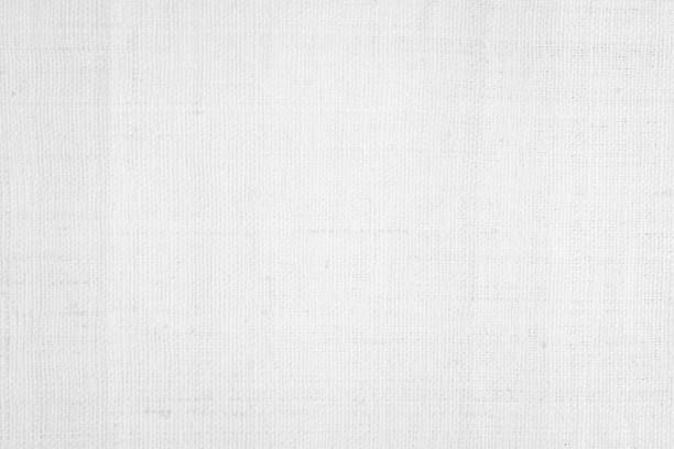 istock White color fabric canvas woven texture background in pattern light blank. Natural gauze linen, carpet wool and cotton cloth textile textured as clean empty for decoration text. Grey sack material. 2199271911