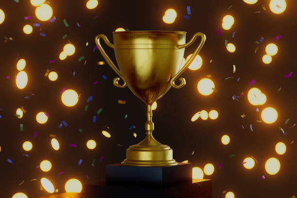 istock A gold cup with a gold rim sits on a black base 2199271947