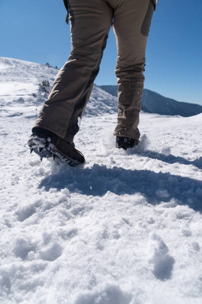 istock Crampons on feet climbing a snowy mountain 2199272156