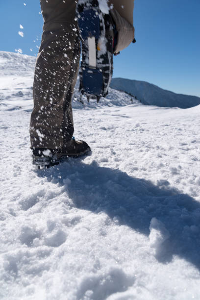 istock Crampons on feet climbing a snowy mountain 2199272239