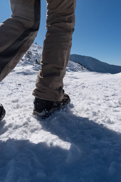 istock Crampons on feet climbing a snowy mountain 2199272293