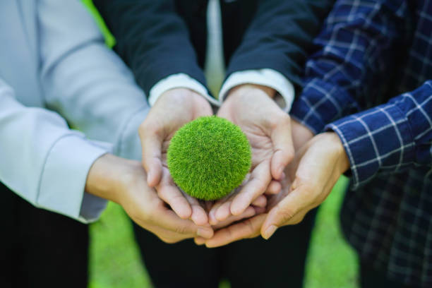 istock team embraces the world, symbolizing sustainability conservation, and cooperation. Hands together they protect nature drive positive change for a greener future. 2199272429
