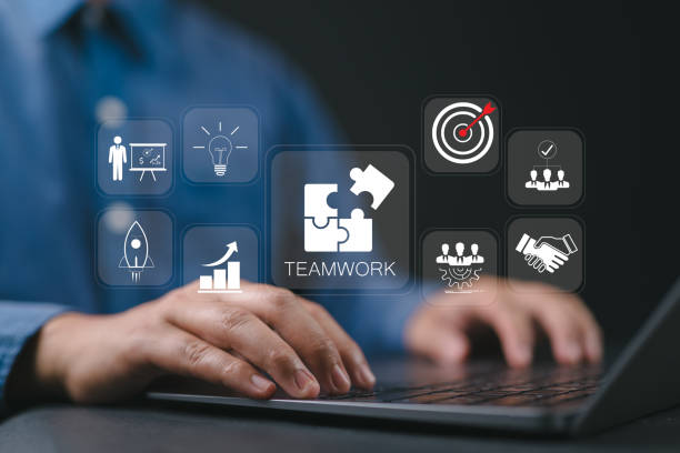 istock Teamwork and partnership concept. Businessman using laptop with teamwork icon on virtual screen. Team business, problem solving, team victory brainstorm, networking and group leader. 2199275779
