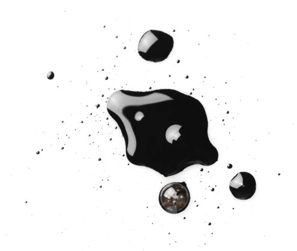istock Blobs of black oil isolated on white, top view 2199276500