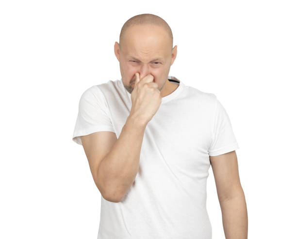 istock Man holding his nose in disgust with a displeased expression 2199278339
