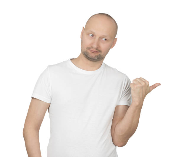 istock Playful man in white t-shirt pointing thumb to the side 2199278701