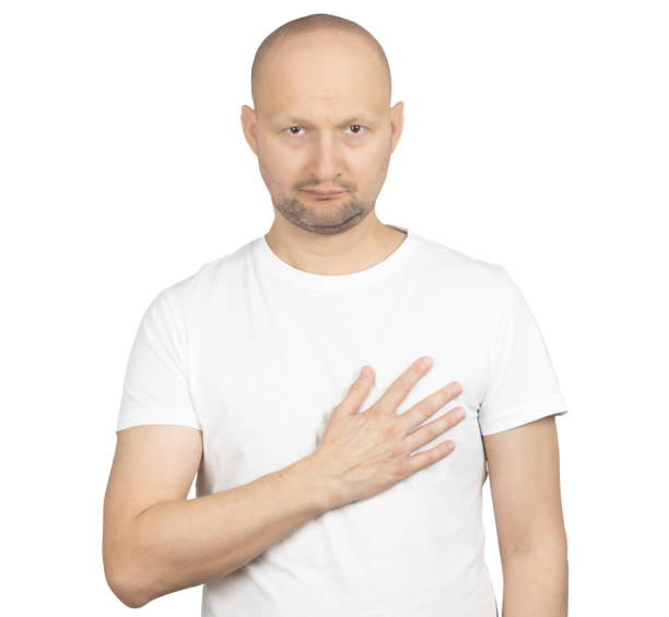 Serious man placing hand on chest in sincere gesture