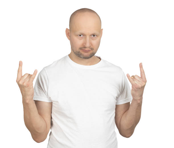 istock Man in a white t-shirt making a rock hand gesture with a serious look 2199279085