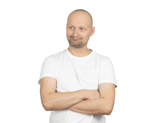 istock Man in a white t-shirt crossing arms with a skeptical expression 2199279147