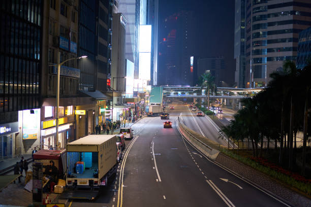 Hong Kong, China - December 5, 2023: night view of Central District, Hong Kong, focusing on the road with city lights and calm traffic creating a quiet nighttime atmosphere.
